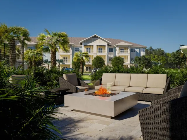 a view of a patio with couches table and chairs and potted plants
