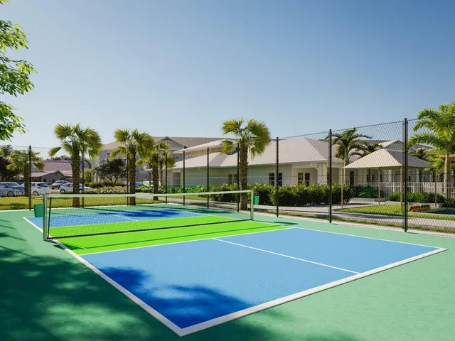 a view of a tennis ground with large trees
