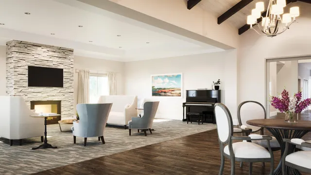 a living room with furniture a dining table and chairs with wooden floor