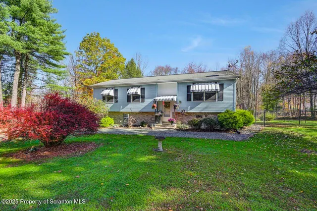 a view of a house with a backyard and a patio
