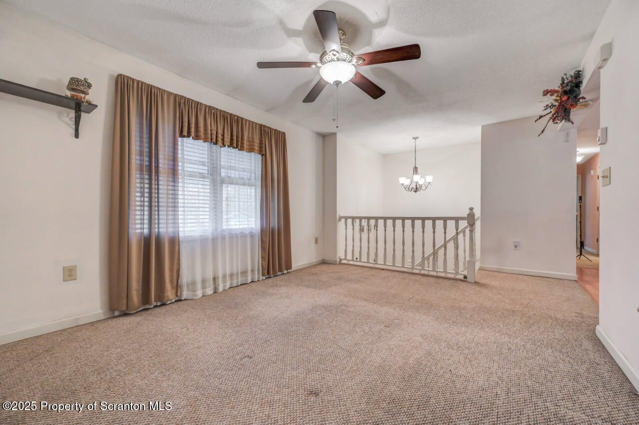 145 Tunnel Road Nicholson, PA 18446 - Photo 14 of 70 a view of a livingroom with a ceiling fan & windows