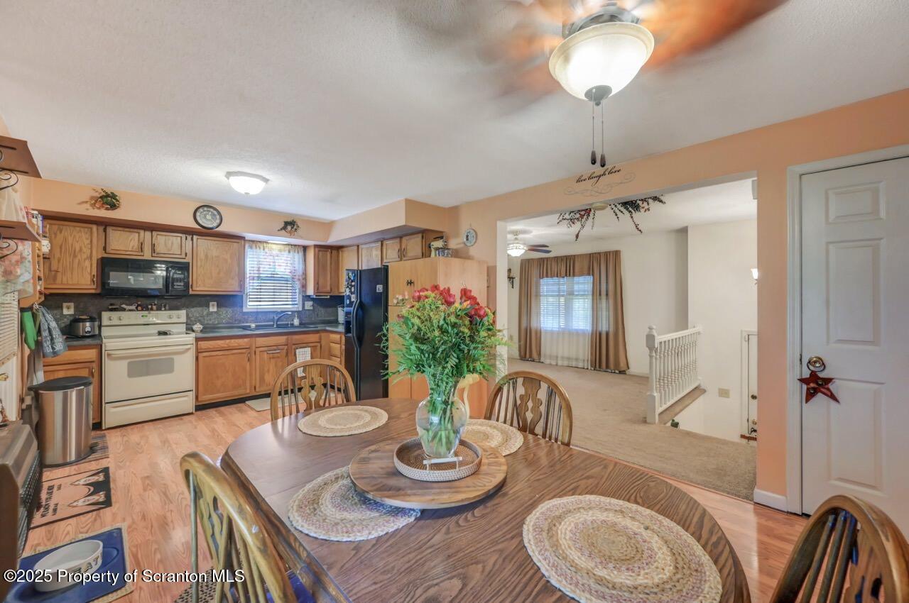 145 Tunnel Road Nicholson, PA 18446 - Photo 17 of 70 a kitchen with stainless steel appliances kitchen island granite countertop a table chairs and a kitchen view