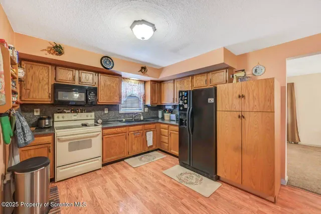 a view of a patio with table and chairs with wooden floor and fence