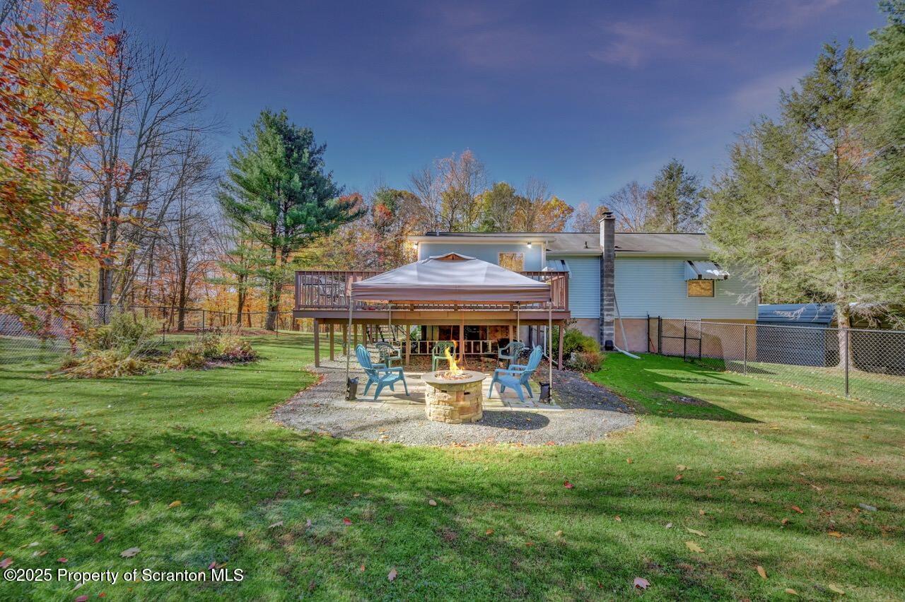145 Tunnel Road Nicholson, PA 18446 - Photo 2 of 70 a view of a patio with a table and chairs under an umbrella