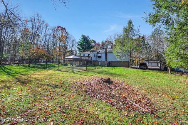 a view of a house with a yard deck and sitting area