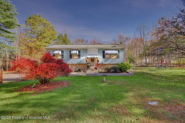 a kitchen with stainless steel appliances kitchen island granite countertop a table chairs and a kitchen view