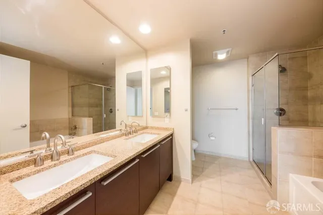 a bathroom with a granite countertop sink mirror and a shower