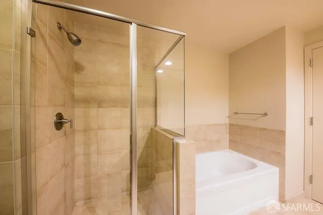 a bathroom with a shower and a tub