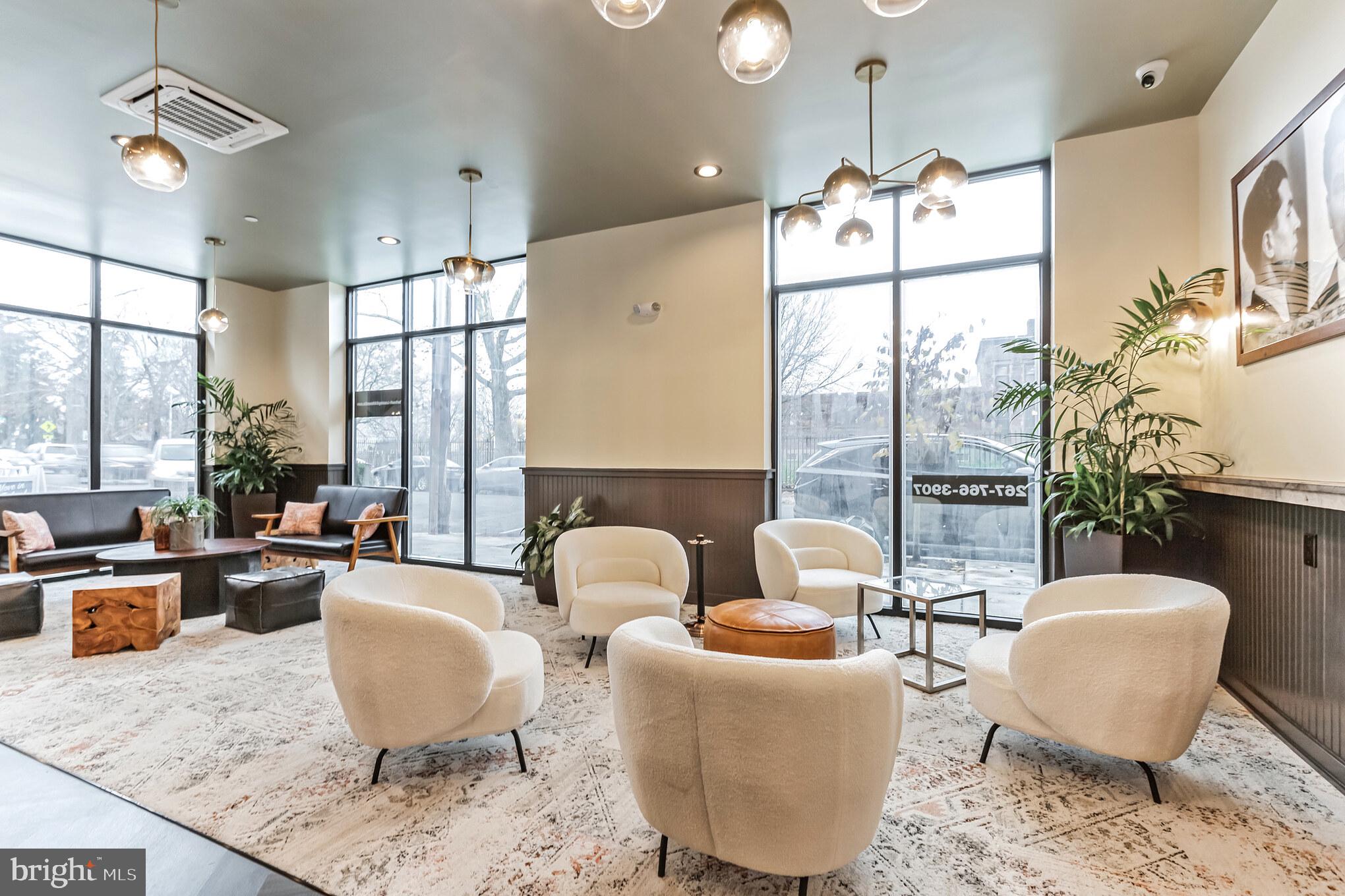 5801 Ridge Avenue, Unit 201 Philadelphia, PA 19128 - Photo 23 of 26 a living room with furniture potted plant and a large window