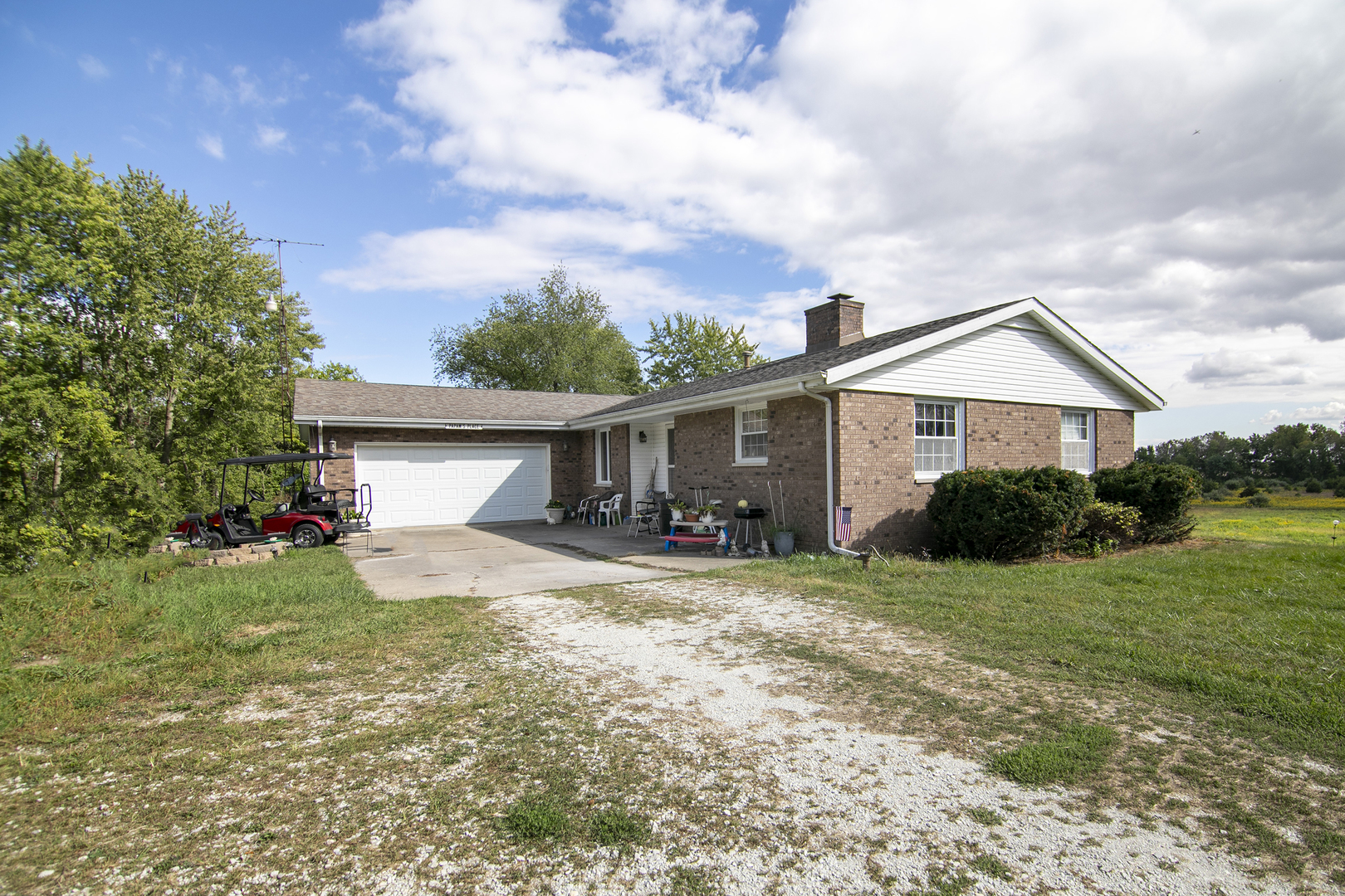 a view of a house with a yard and large tree