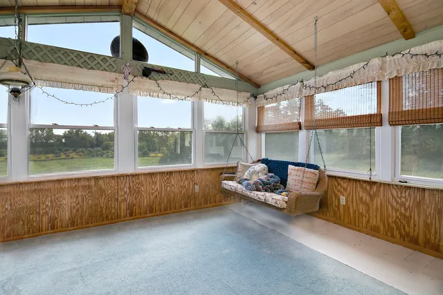 a view of balcony with wooden floor and fence