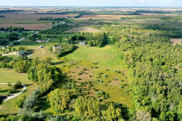 an aerial view of a house with pool garden and outdoor seating