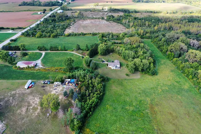 an aerial view of a house with a yard