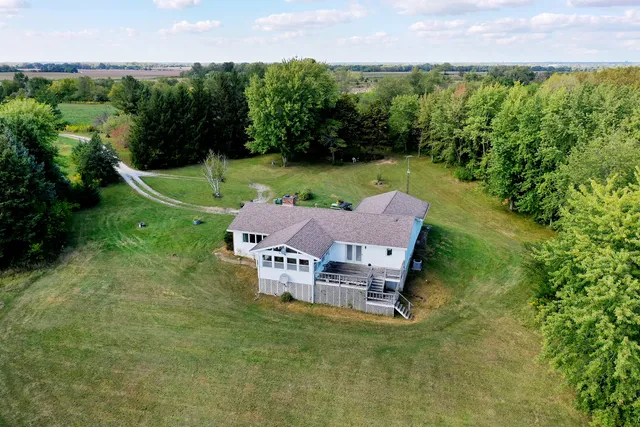 a backyard of a house with lots of green space and trampoline