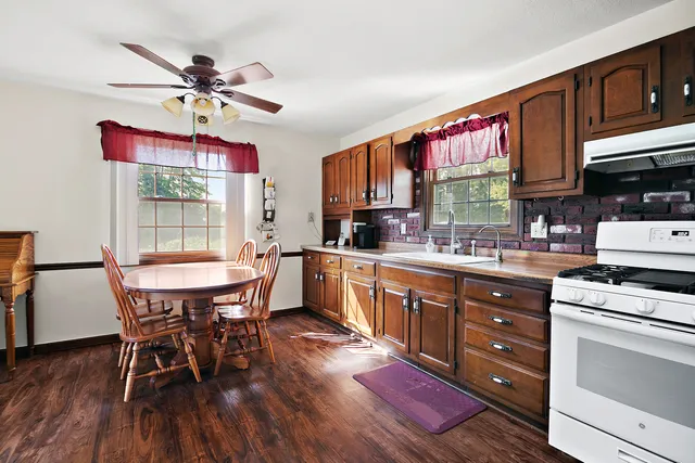 a kitchen with a wooden table and chairs