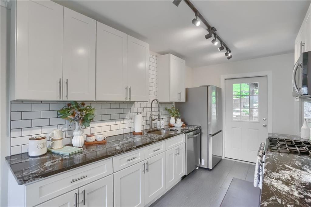 5216 Verona Road Verona, PA 15147 - Photo 20 of 42 a kitchen with stainless steel appliances granite countertop a sink and a refrigerator