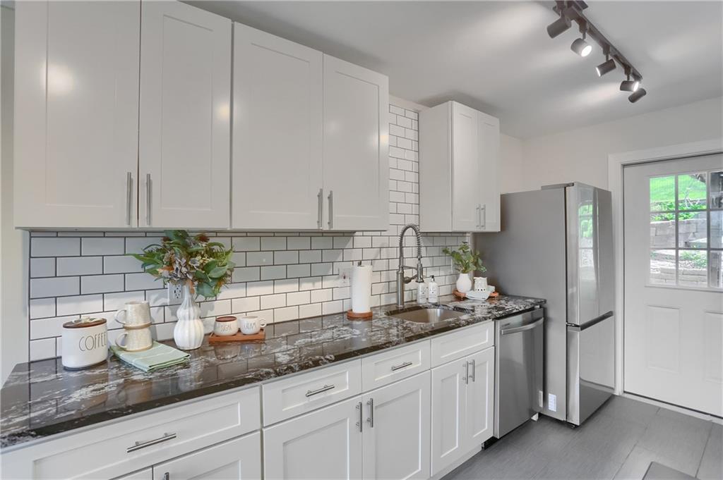 5216 Verona Road Verona, PA 15147 - Photo 21 of 42 a kitchen with stainless steel appliances granite countertop a sink a refrigerator and a counter space