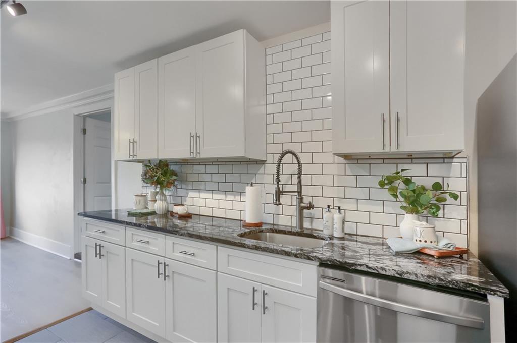 5216 Verona Road Verona, PA 15147 - Photo 23 of 42 a kitchen with granite countertop white cabinets and a white stove