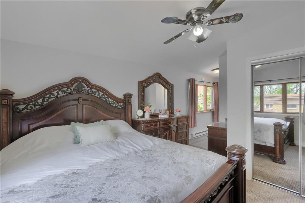 5216 Verona Road Verona, PA 15147 - Photo 30 of 42 a bedroom with a bed and a chandelier