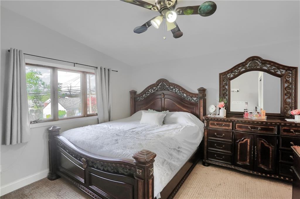 5216 Verona Road Verona, PA 15147 - Photo 31 of 42 a bedroom with a bed and dresser with mirror