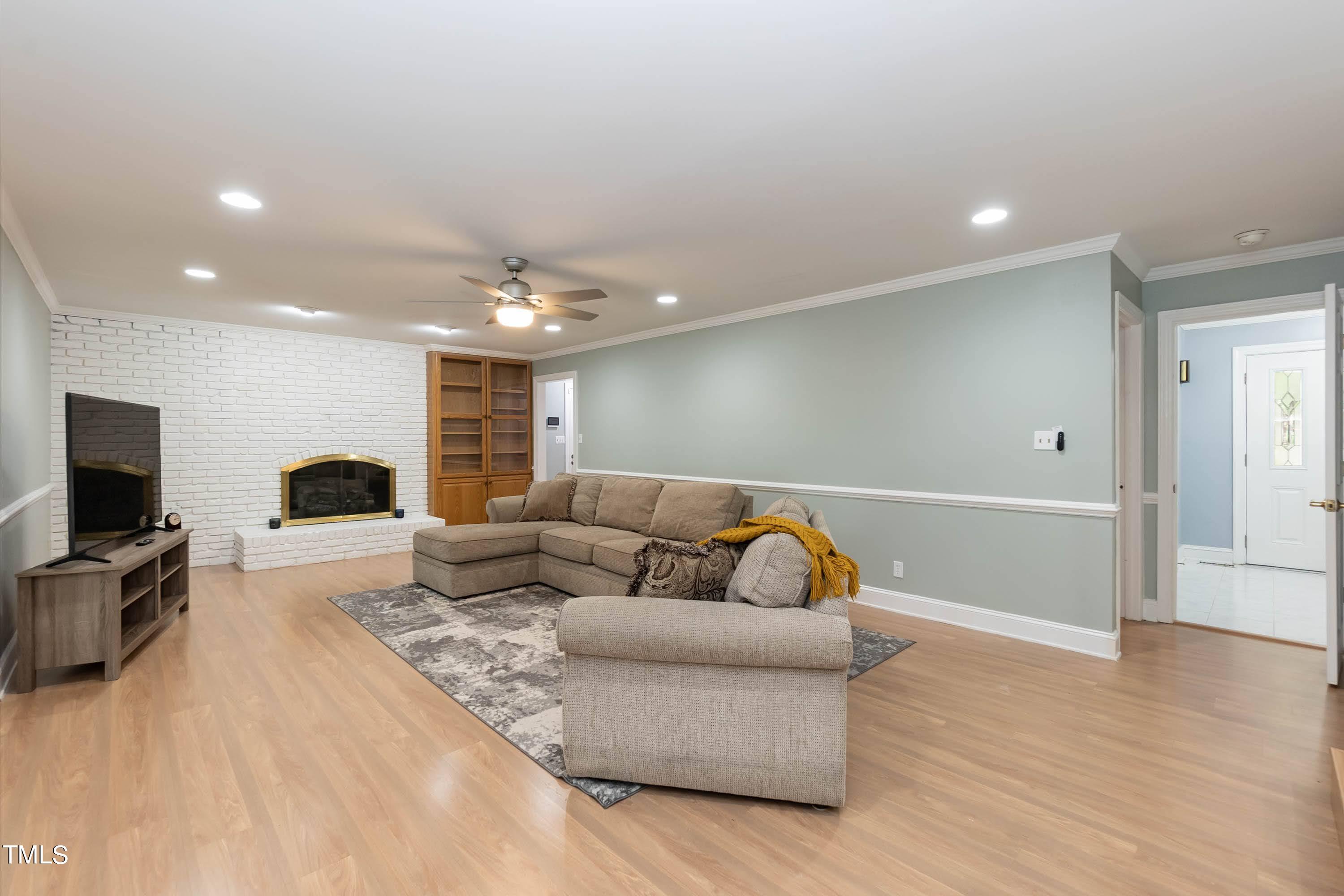 9209 Oneal Road Raleigh, NC 27613 - Photo 11 of 53 a living room with furniture and a flat screen tv