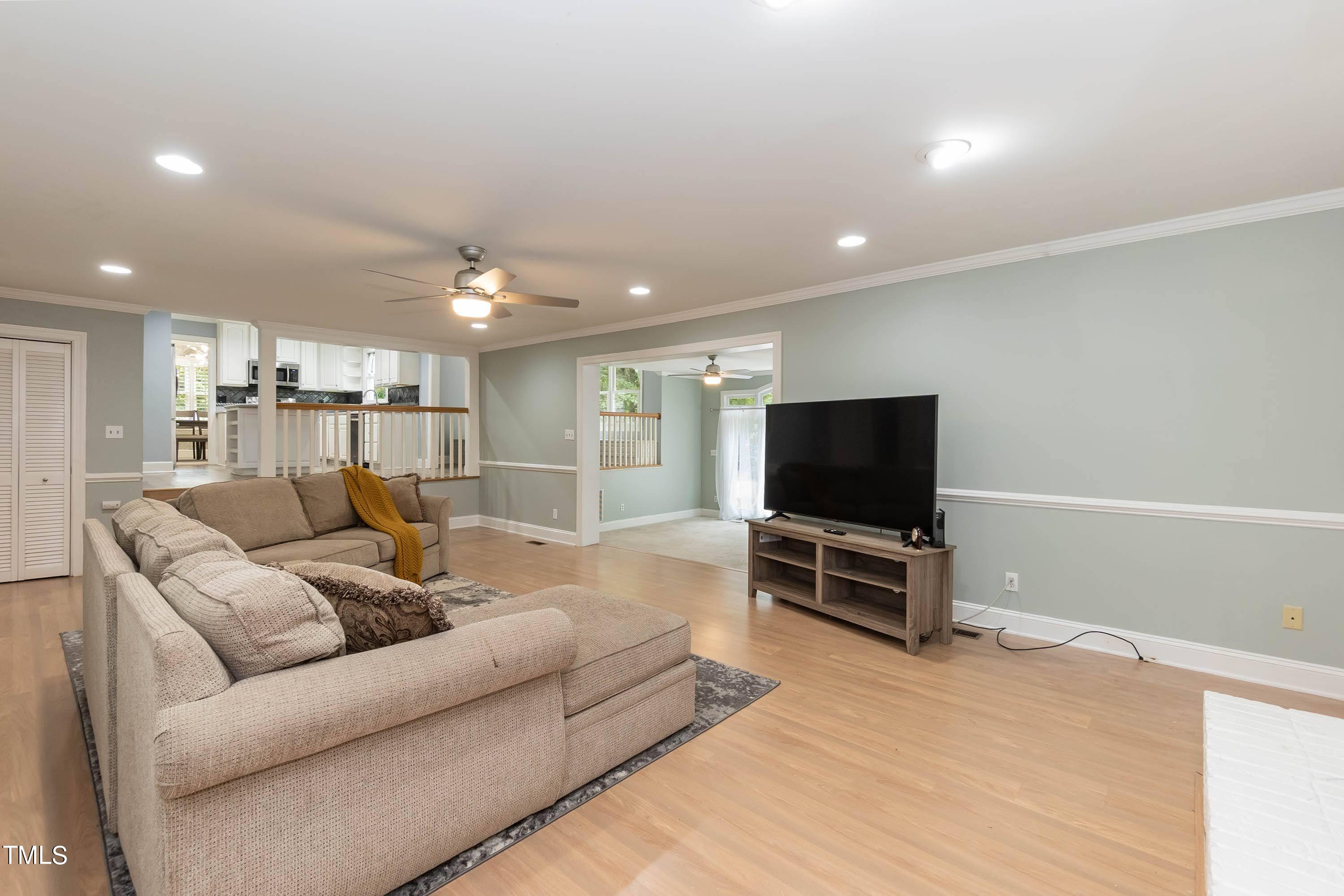 9209 Oneal Road Raleigh, NC 27613 - Photo 12 of 53 a living room with furniture and a flat screen tv
