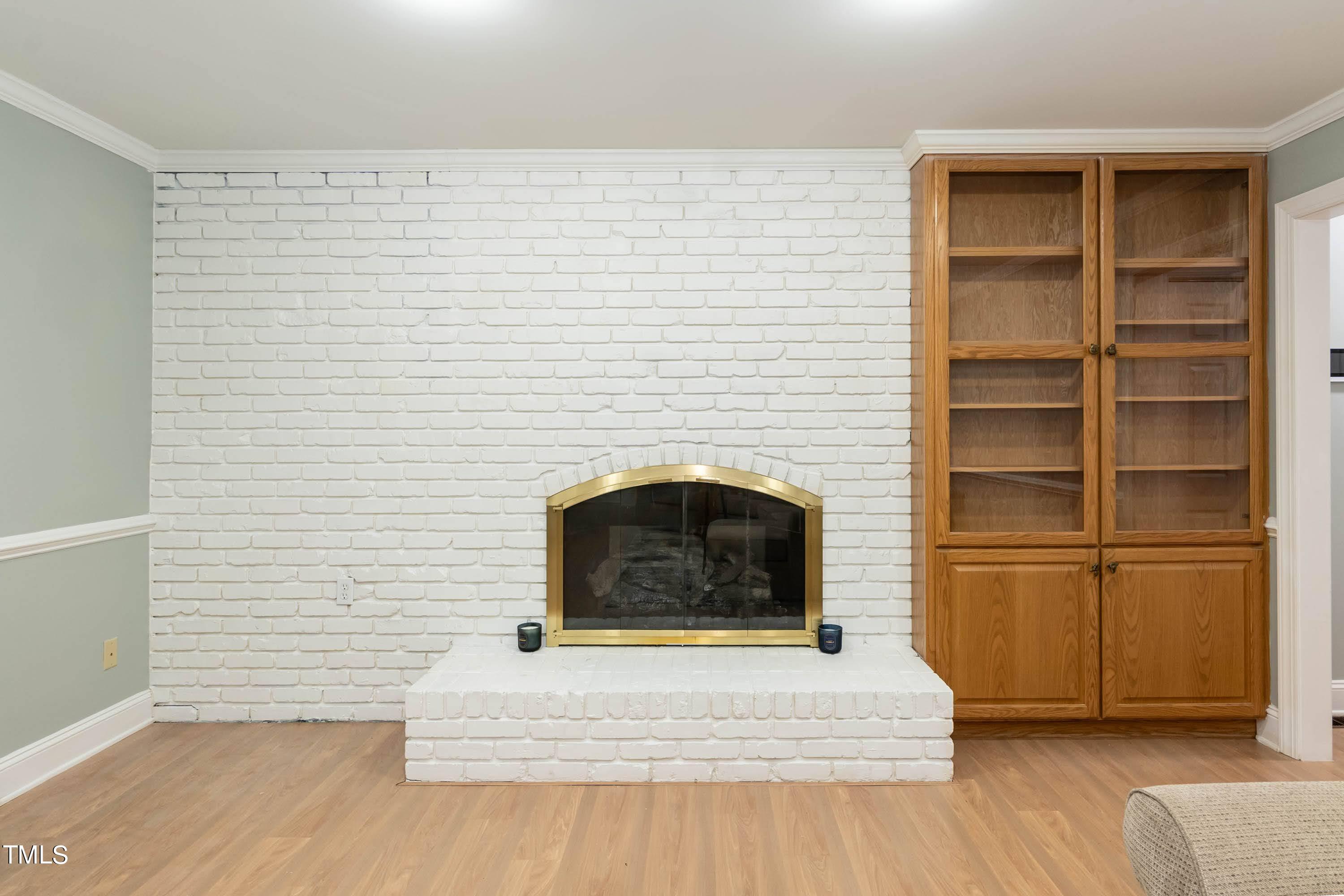 9209 Oneal Road Raleigh, NC 27613 - Photo 13 of 53 a living room with a fireplace and a rug