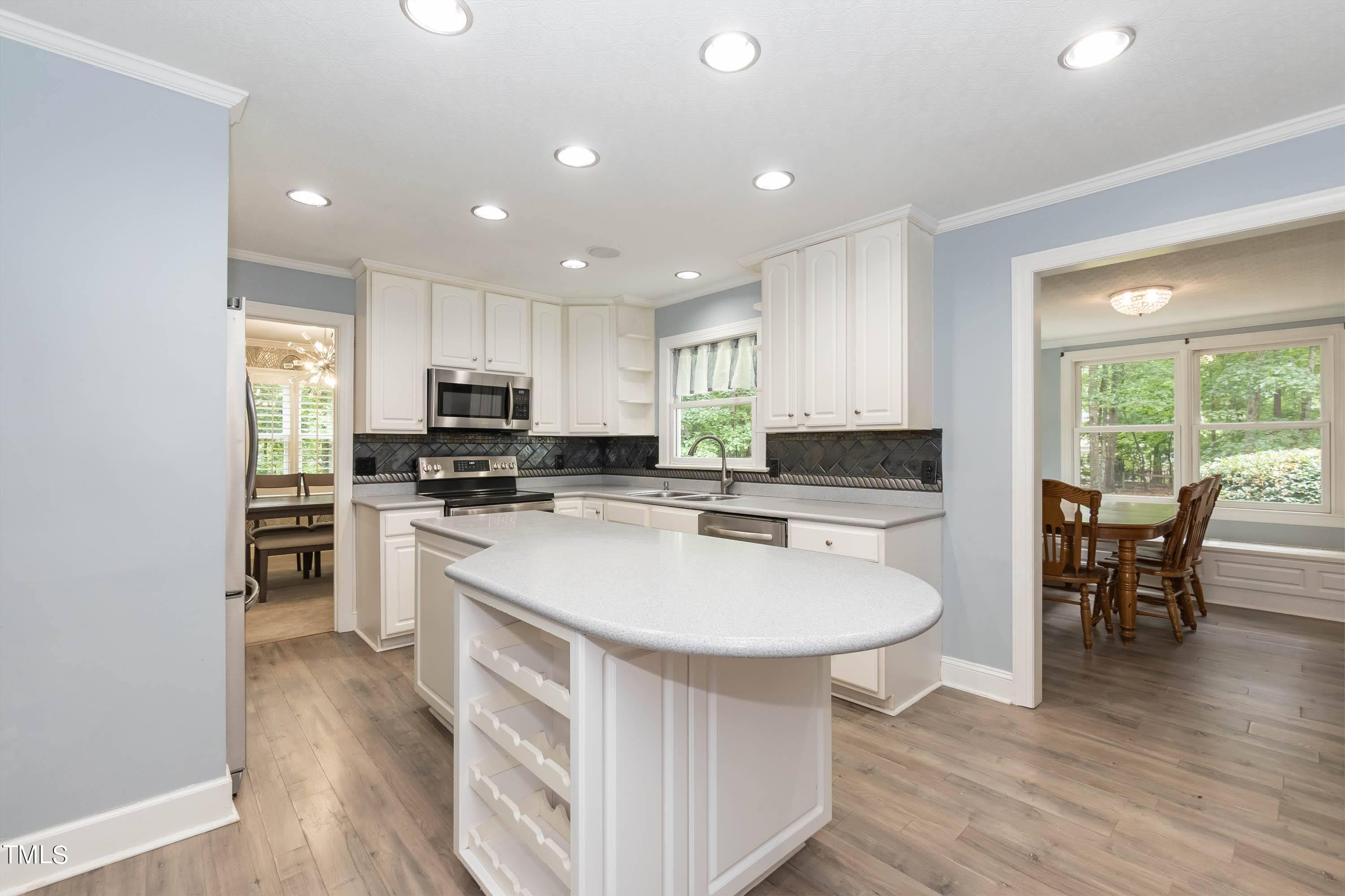9209 Oneal Road Raleigh, NC 27613 - Photo 19 of 53 a kitchen with a sink a counter top space and stainless steel appliances