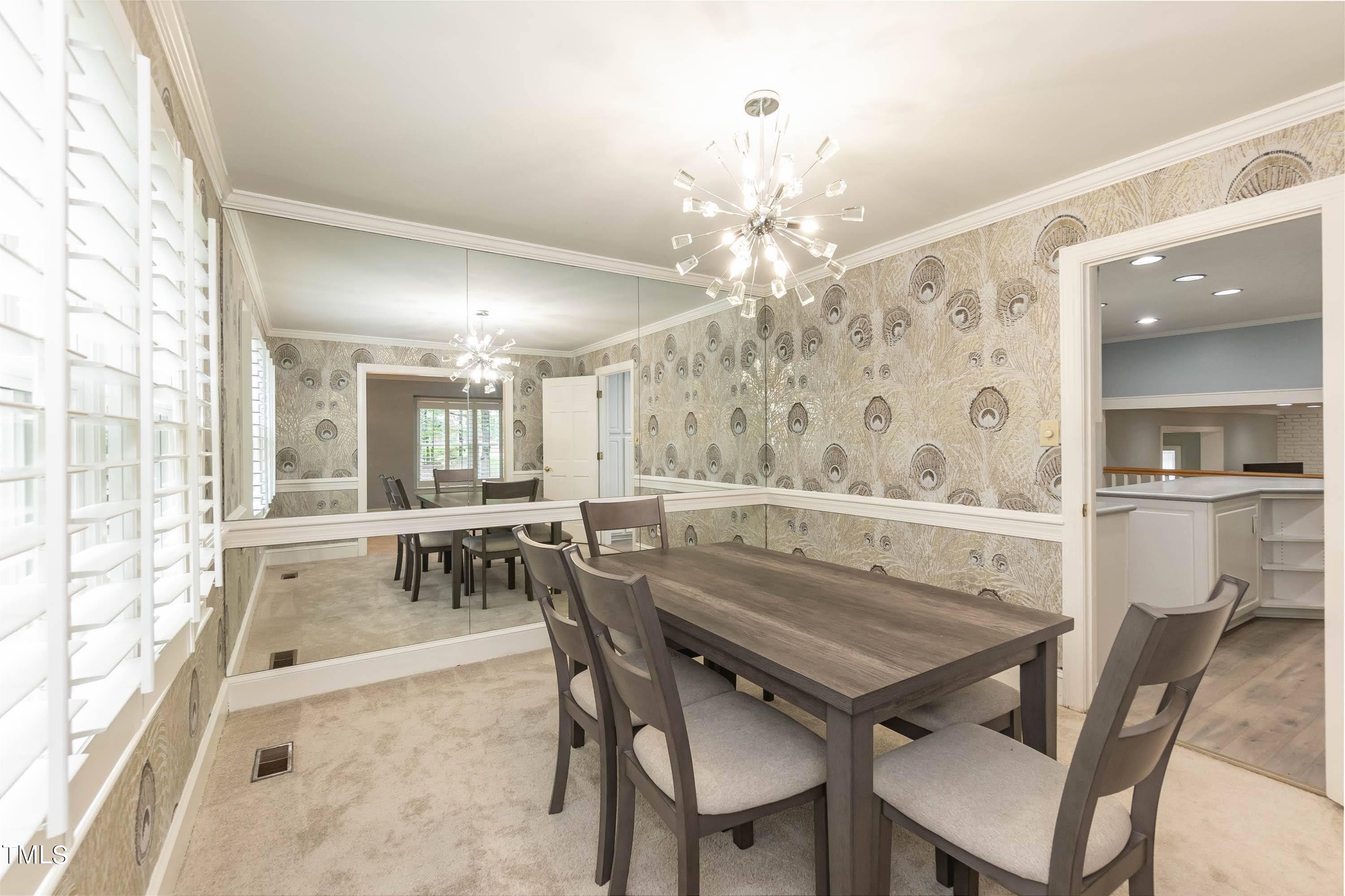 9209 Oneal Road Raleigh, NC 27613 - Photo 23 of 53 a dining room with furniture a chandelier and wooden floor