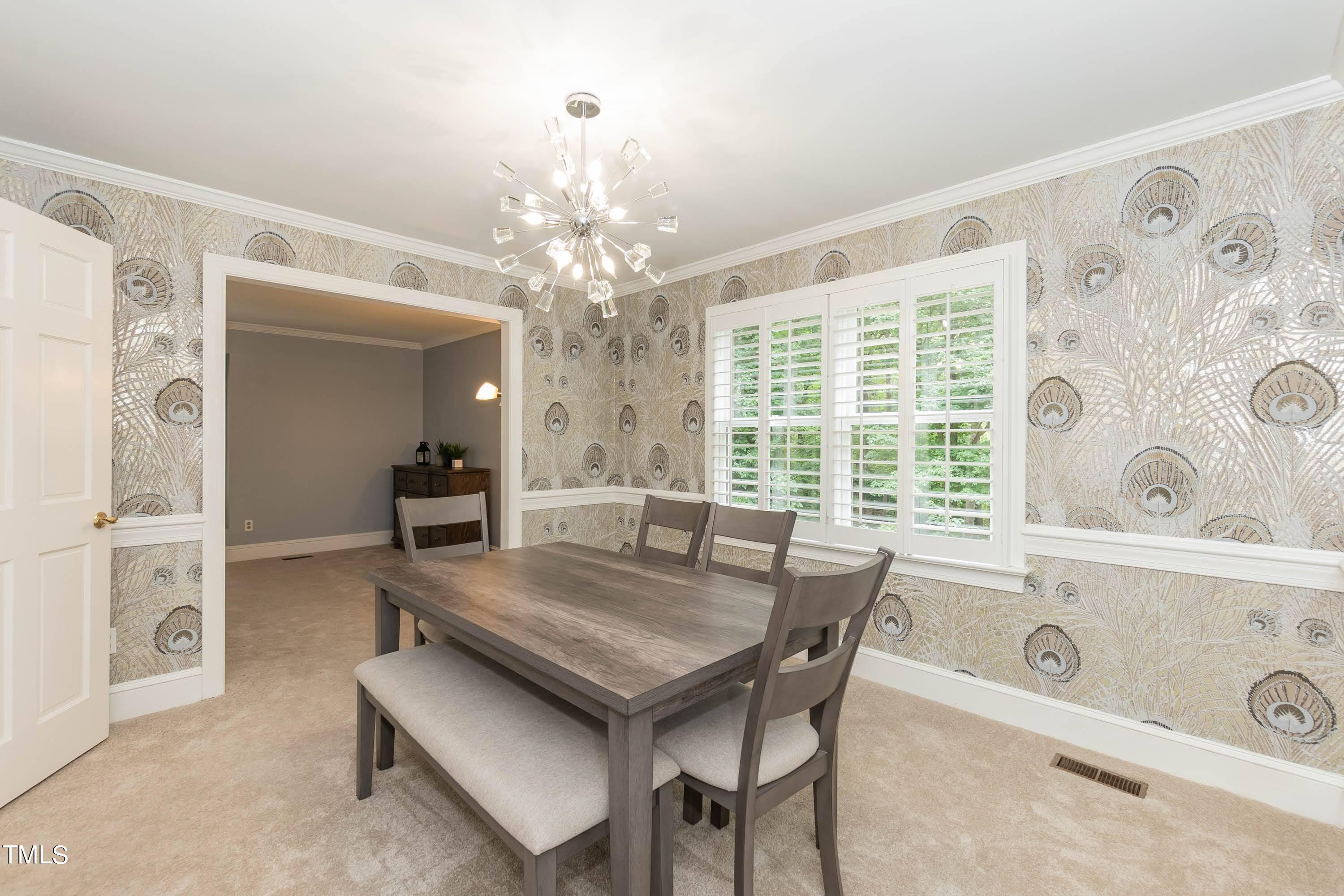 9209 Oneal Road Raleigh, NC 27613 - Photo 24 of 53 a view of a dining room with furniture and chandelier