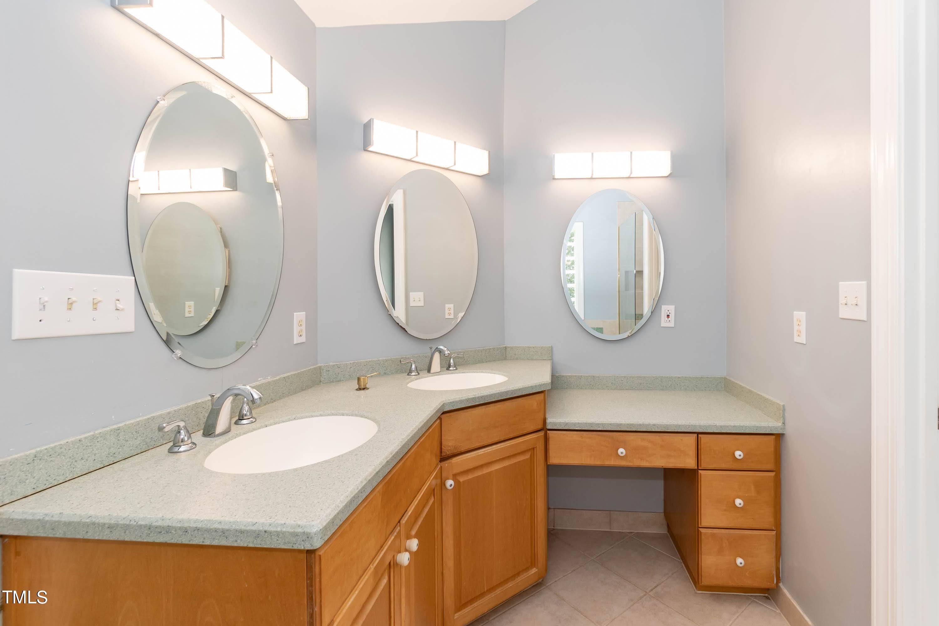 9209 Oneal Road Raleigh, NC 27613 - Photo 31 of 53 a bathroom with a granite countertop double vanity sink and a mirror