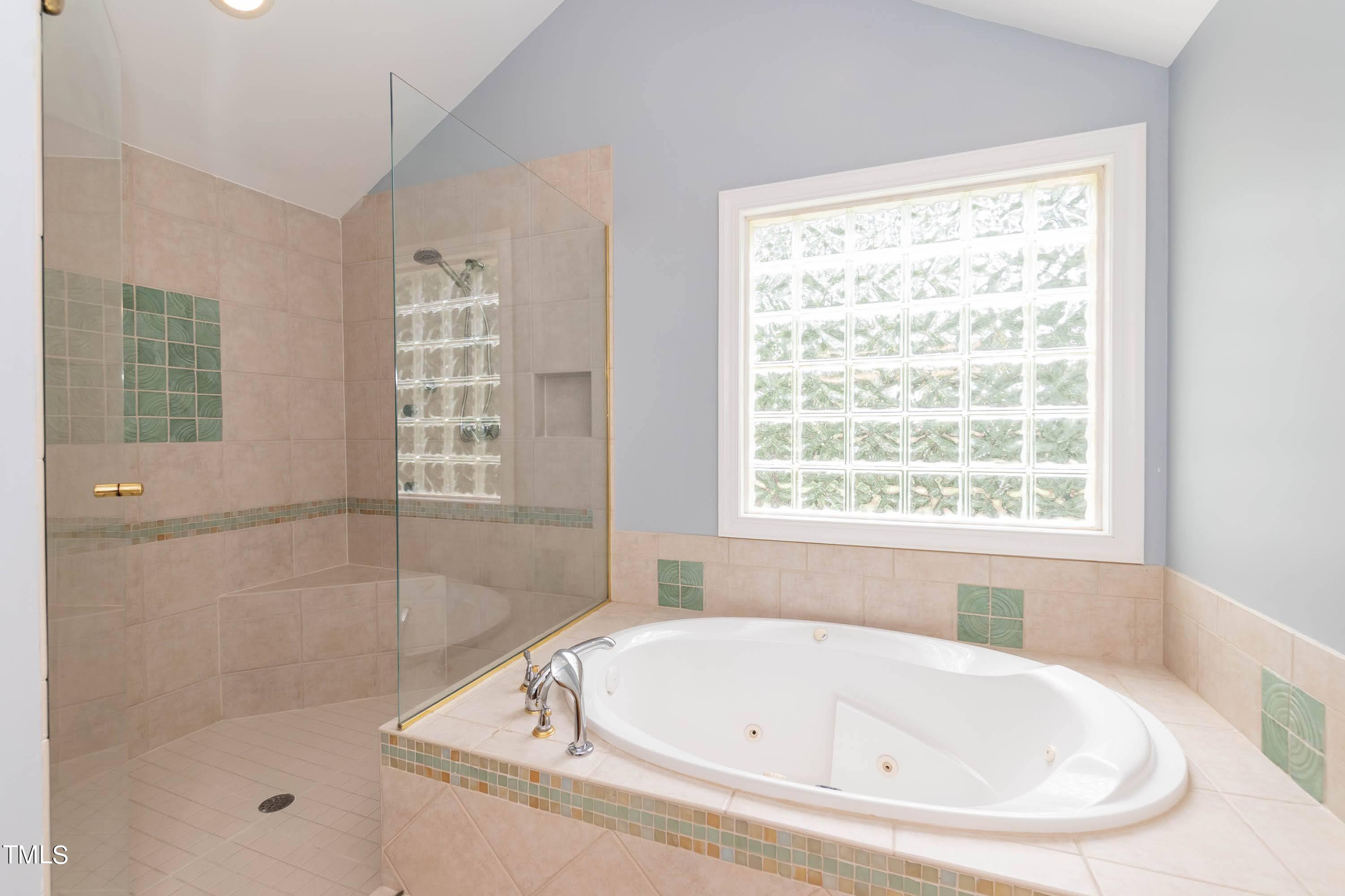 9209 Oneal Road Raleigh, NC 27613 - Photo 32 of 53 a white bath tub sitting next to a window