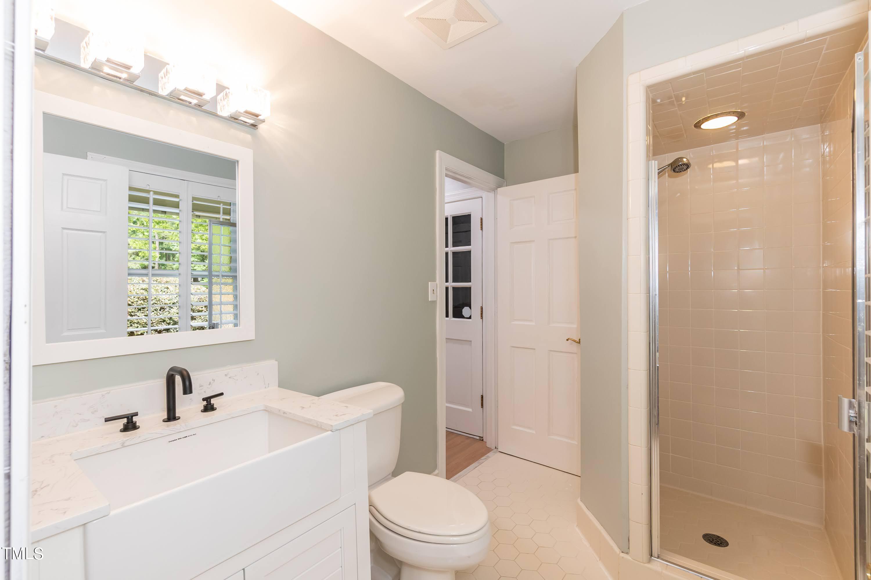 9209 Oneal Road Raleigh, NC 27613 - Photo 39 of 53 a bathroom with a sink a toilet and shower