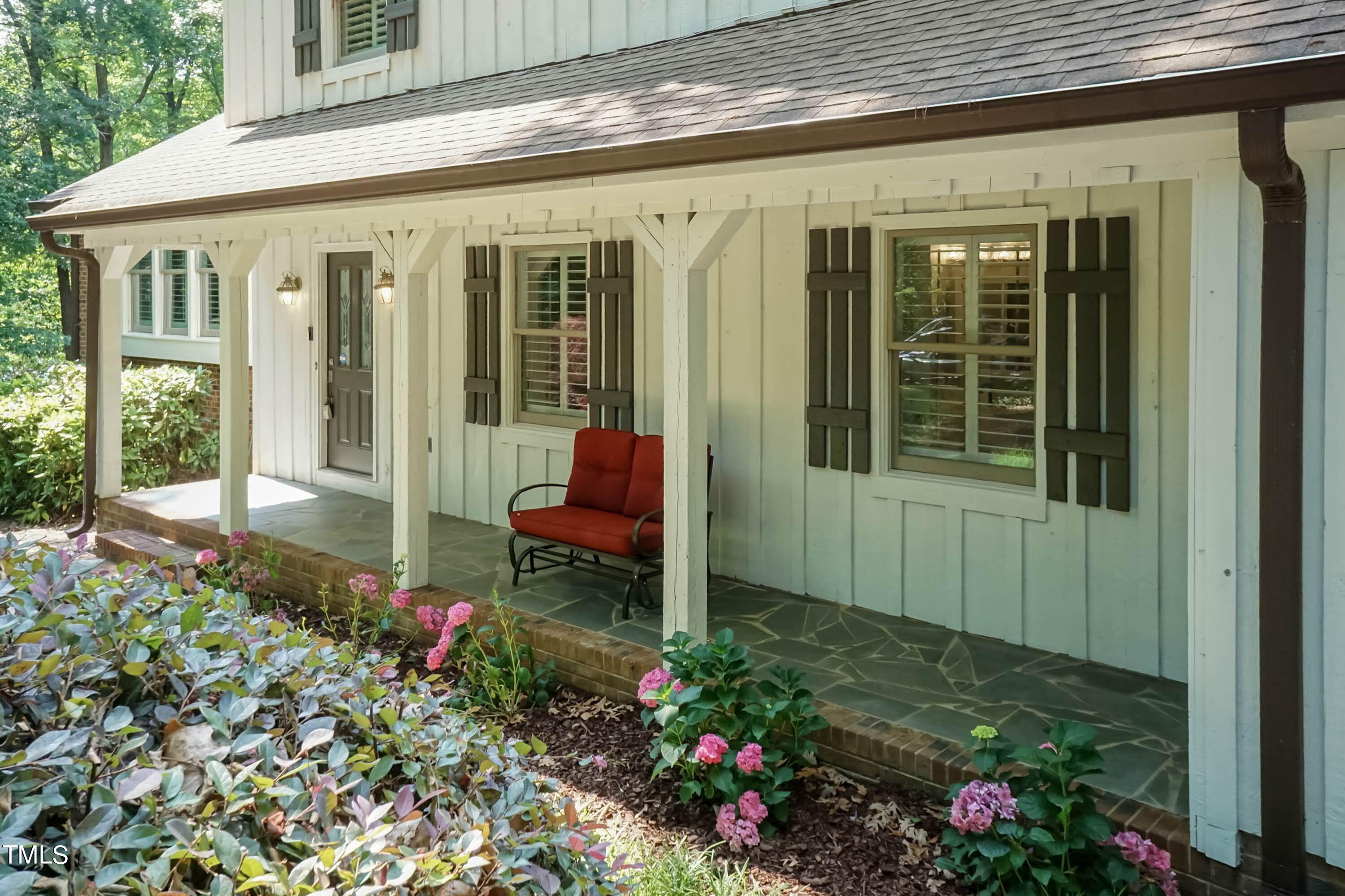 9209 Oneal Road Raleigh, NC 27613 - Photo 6 of 53 a view of a porch with chairs and potted plants