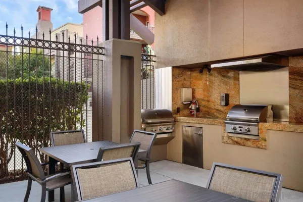 a kitchen with a table chairs stove and cabinets