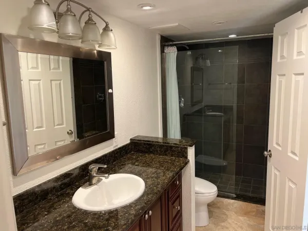 a bathroom with a sink toilet and shower
