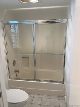 a bathroom with a glass shower door