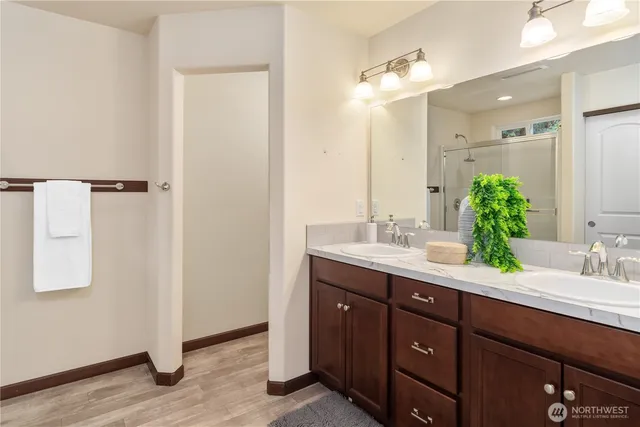 a bathroom with a double vanity sink and mirror