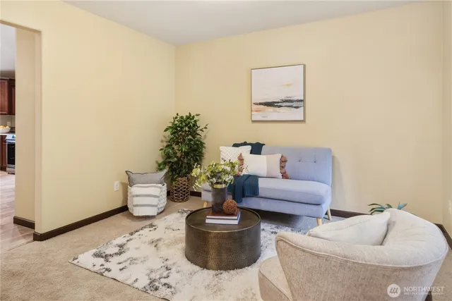 a living room with furniture and a potted plant