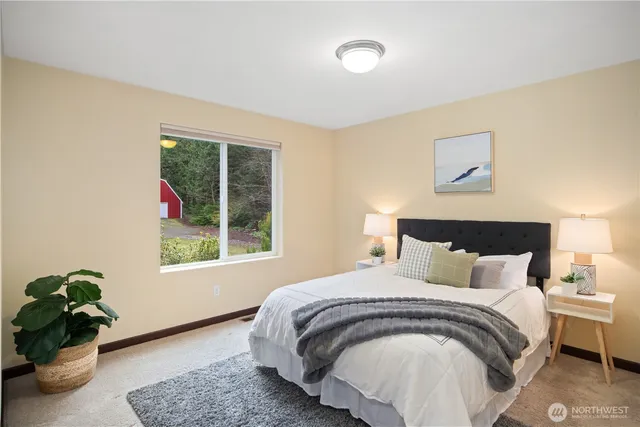 a bedroom with a bed and a window