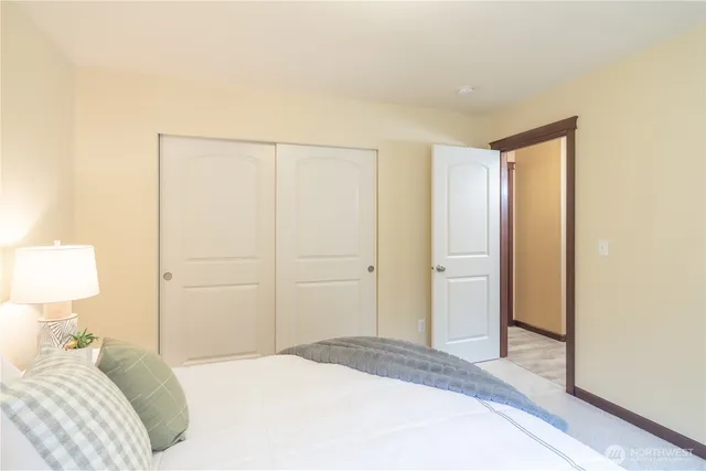 a bedroom with a bed and a lamp