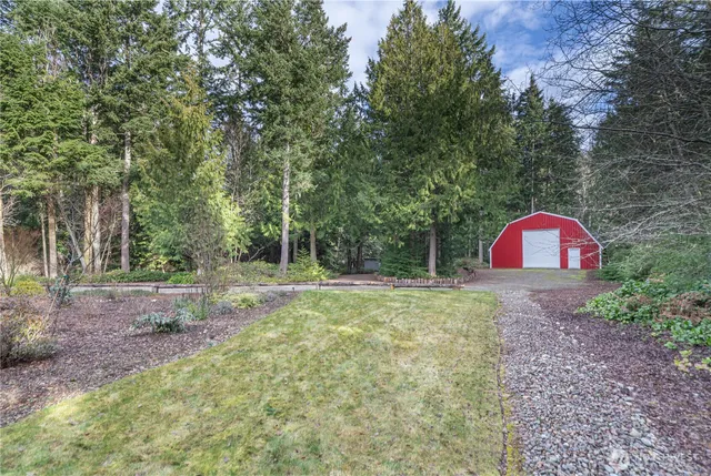 a view of a wooden fence with a trees in the background