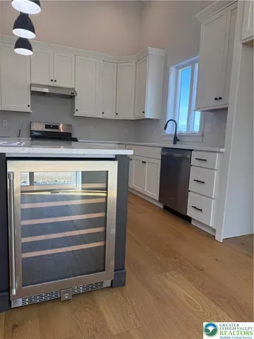 a view of a hallway with wooden floor and stairs