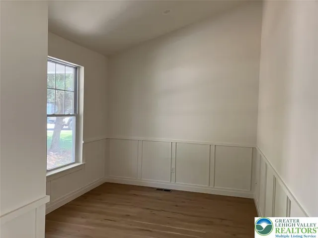 a kitchen with white cabinets and sink