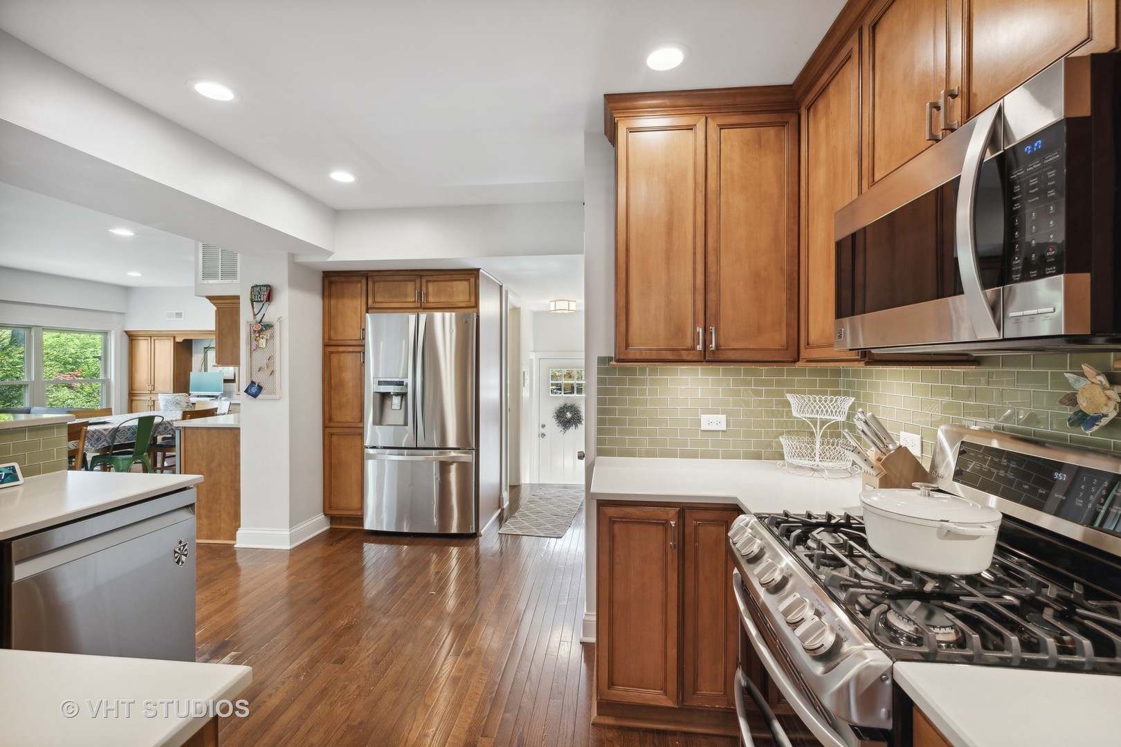 526 Uvedale Road Riverside, IL 60546 - Photo 11 of 34 a kitchen with stainless steel appliances a stove a sink a microwave and wooden cabinets