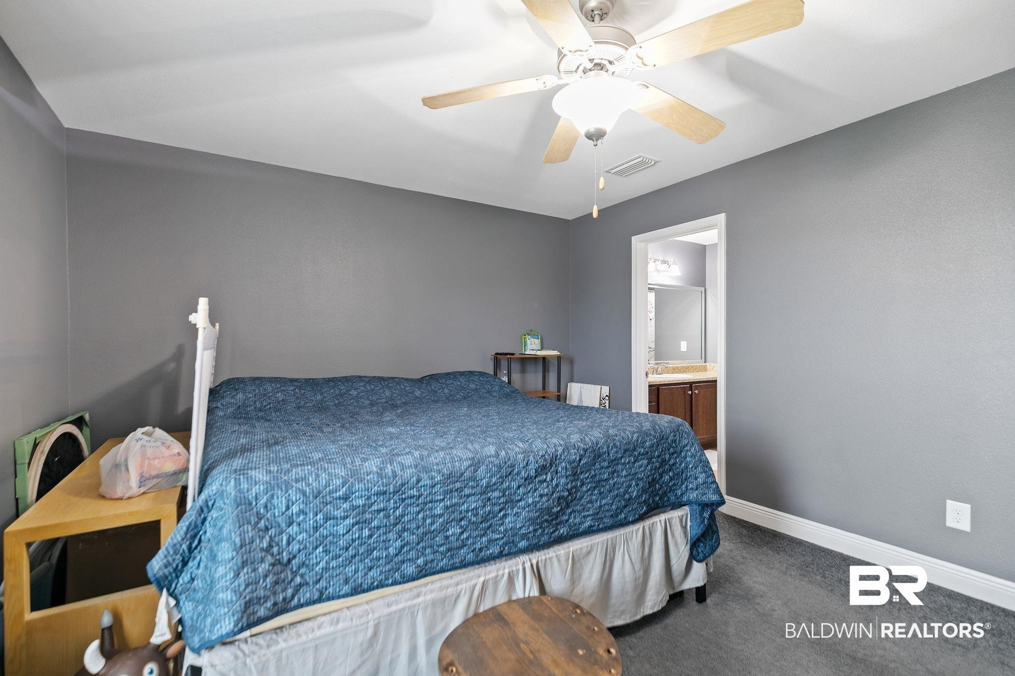 15573 Talus Court Foley, AL 36535 - Photo 23 of 50 Carpeted bedroom with ensuite bath and ceiling fan