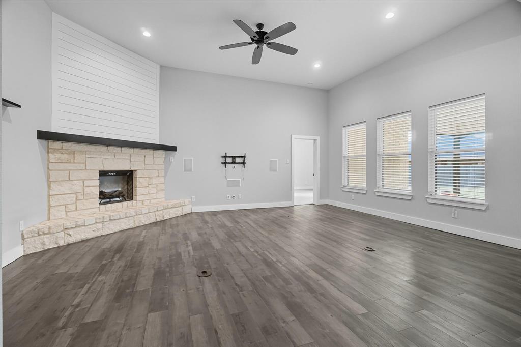 6502 Randy Avenue Abilene, TX 79606 - Photo 10 of 37 an empty room with wooden floor ceiling fan and windows