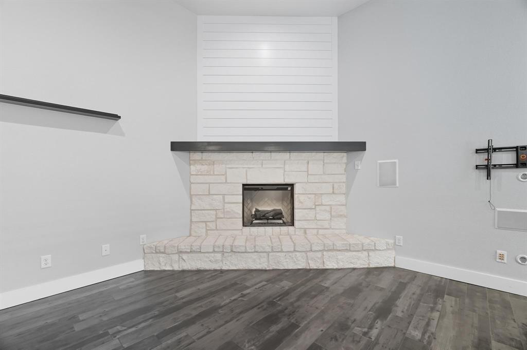 6502 Randy Avenue Abilene, TX 79606 - Photo 12 of 37 an empty room with wooden floor and fireplace