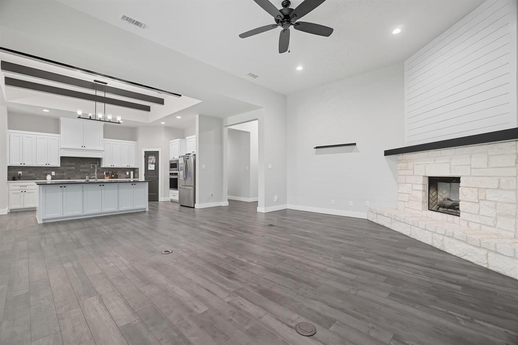 6502 Randy Avenue Abilene, TX 79606 - Photo 13 of 37 an empty space with wooden floor and kitchen view