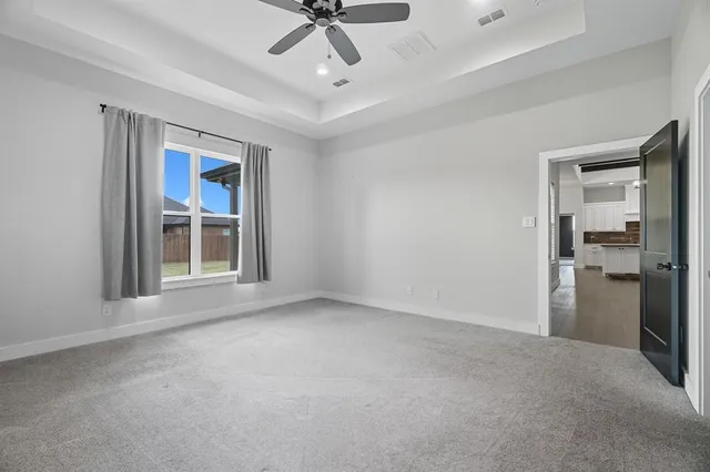 an empty room with wooden floor and fireplace